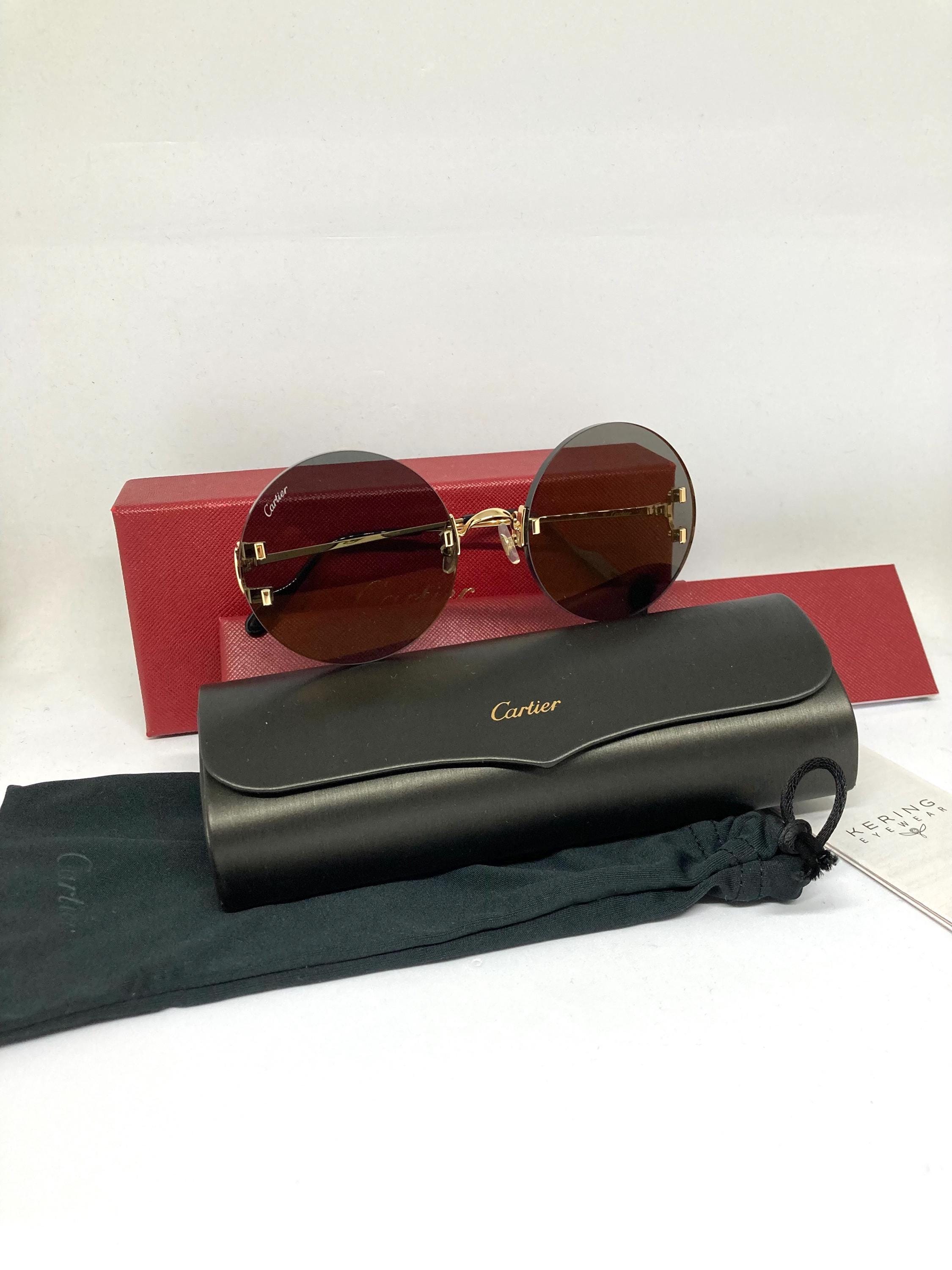 Cartier Eyewear
C Décor round-frame sunglasses CARTIER EYEWEAR Signature C Décor rimless cat-eye gold-tone  main image 3