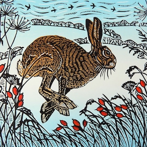Yuletide Hare- Limited edition lino print of a hare running through a snowy landscape in Winter