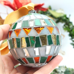 Christmas balls decorated by hand in Italy. Artistic glass mosaic Christmas balls. Christmas ornament in mosaic. Mix verde