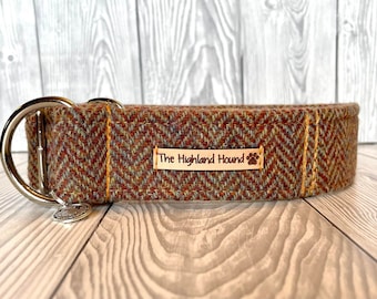 May include: A brown, green, and orange tweed dog collar with a silver buckle and a leather tag that reads "The Highland Hound".