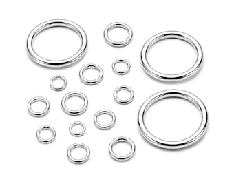May include: A collection of fifteen smooth, circular metal rings in varying sizes, arranged in a scattered formation. Each ring features a polished, reflective silver-toned finish with a consistent rounded cross-section and a seamless, closed loop design.