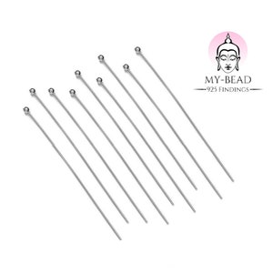 May include: Ten silver head pins with round heads. The pins are arranged in a fan shape. MY-BEAD 925 FINDINGS is printed on the image.