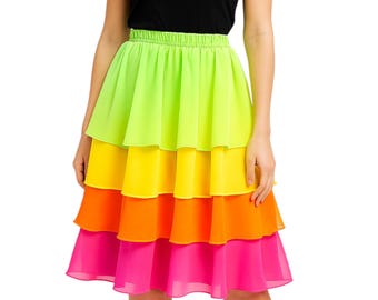 May include: A tiered skirt in vibrant neon colors: lime green, yellow, orange, and hot pink. The skirt has an elastic waistband and a flowing, layered design. The skirt is knee-length and made of a lightweight fabric.