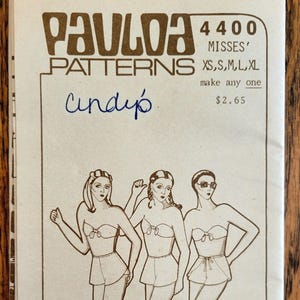 May include: Vintage Paula Patterns 4400 Misses' sewing pattern. The cover features illustrations of women in swimwear. The pattern includes sizes XS, S, M, L, and XL. The word "Cindy" is written in blue ink on the cover.