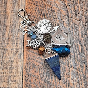 May include: A white ceramic mug with a black handle and the text "But First, Coffee" in a black, handwritten-style font. The mug is on a white surface.