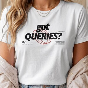 May include: A white short-sleeved t-shirt featuring the black text "got QUERIES?" centered on the chest. The design includes a red circular graphic, small black coordinate text, and a block of small black text on the right side of the shirt.