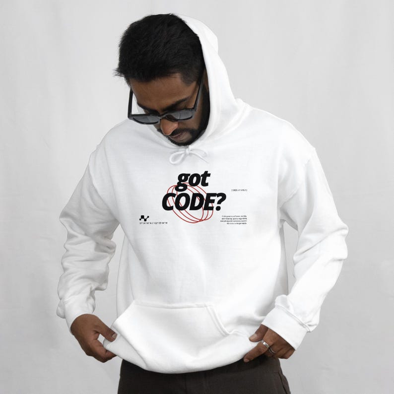 Model wearing a white colored Gildan G18500 pullover hoodie with a retro-tech graphic design featuring the phrase GOT CODE? in bold typography over red orbital linework with small technical details and humorous token-themed microtext.