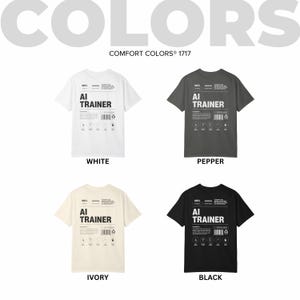 May include: Four t-shirts in white, pepper, ivory, and black, each featuring the text "AI TRAINER" in a bold font. The shirts are labeled with their respective colors and include additional text and graphics.