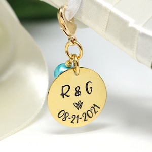 personalized bridal bouquet charm in gold with aqua pearl attached to bouquet