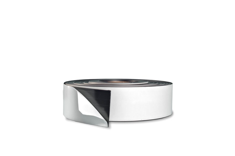 May include: A roll of white magnetic tape with a black backing. The tape is rolled up and a portion of the tape is unrolled, showing the white side.