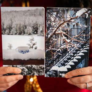 A duo of winter notebooks featuring a black and white photograph of Montreal's snow-covered spiral walk-up stairs with parked bicycles covered in snow. 

The hand-bound notebooks measure 5x8 inches. They contain 48 pages of cream-white acid free paper with a smooth finish. The matte cover is smooth and scuff-resistant!

Each notebook comes with an insert containing 15 insightful journaling prompts!