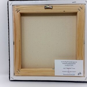 May include: The back of a stretched canvas painting with a wooden frame. A white label with black text is attached to the frame. The text reads "The MindfulPaw&trade; has been expertly designed to satisfy your creativity one light at a time. Enjoy - Appreciate - Thrive A product of "The Paw Season"  www.thepawseason.etsy.com"