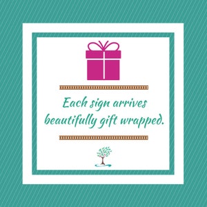 May include: A white square with a teal border and a pink gift box inside. The text "Each sign arrives beautifully gift wrapped." is below the box. A small tree with green leaves is below the text.