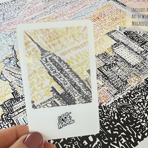 May include: A detailed map print featuring a cityscape with the Empire State Building highlighted. The print includes the text "Includes an Art of Words Magnifier!" and is overlaid with various city names and landmarks.