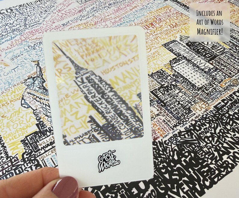 May include: A detailed map print featuring a cityscape with the Empire State Building highlighted within a white frame. The map is filled with text and includes a magnifying glass with the text "Includes an Art of Words Magnifier!"