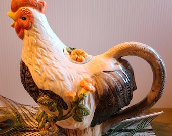 Tetera de cerámica vintage con forma de gallo y asa en la cola.