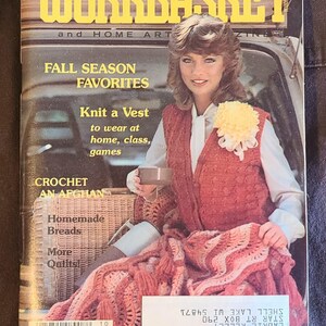 May include: The Workbasket magazine cover from October 1981 features a woman wearing a red knit vest and holding a cup. The cover text includes "Fall Season Favorites" and "Knit a Vest". A crocheted afghan is also visible.