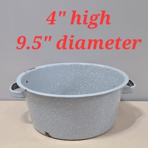 May include: A white enamelware bowl with two handles. The bowl is 9.5 inches in diameter and 4 inches high.