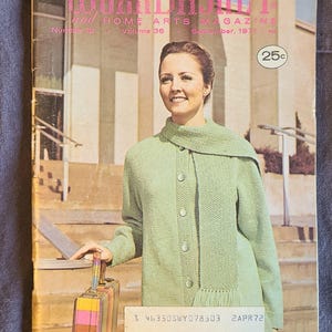 May include: Cover of "The Workbasket" magazine, September 1971, featuring a woman in a light green knit jacket and scarf. The magazine cover has the text "The Workbasket and Home Arts Magazine". The price is 25 cents.