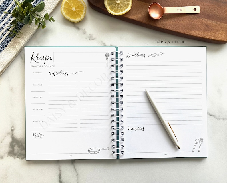 May include: An open recipe book with a teal cover and white pages. The book has a spiral binding and is titled "Recipe" and "Directions". The book is open to a page with a section for ingredients, prep time, cook time, total time, difficulty, and notes. The opposite page has a section for directions and memories.