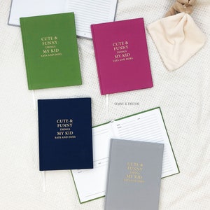 May include: Four different colored notebooks with the text "Cute & Funny Things My Kid Says and Does" on the front cover. The notebooks are green, pink, blue, and gray.
