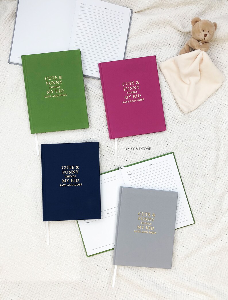 May include: Four different colored notebooks with the text "Cute & Funny Things My Kid Says and Does" on the front cover. The notebooks are green, pink, blue, and gray.