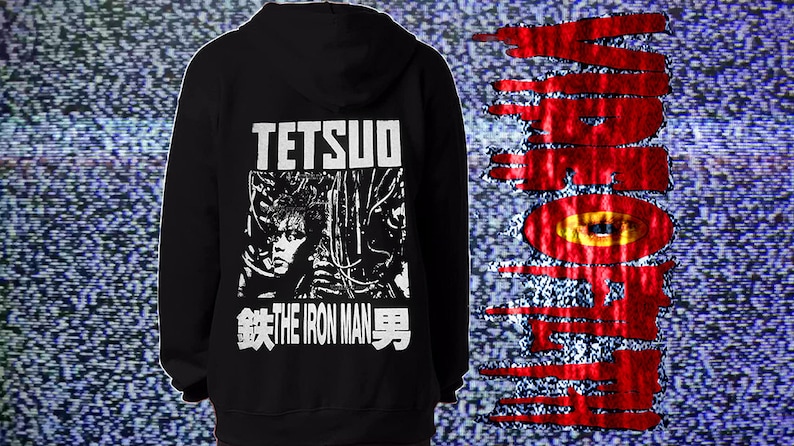 May include: Black hooded sweatshirt with a white graphic print of a character from the movie "Tetsuo: The Iron Man". The graphic includes the text "Tetsuo" and "The Iron Man" in Japanese and English.