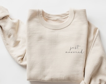 May include: A beige sweatshirt with the text "just married" in black script on the front.