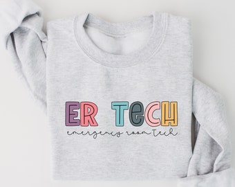 May include: A gray sweatshirt with the text "ER TECH" in rainbow colors and the words "emergency room tech" in black script below.