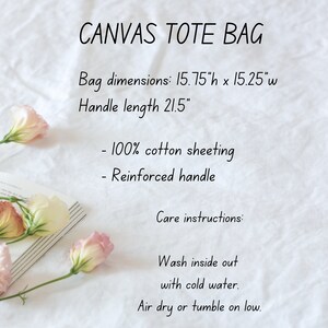 May include: A white canvas tote bag with the text "CANVAS TOTE BAG" in black. The bag measures 15.75 inches high by 15.25 inches wide, with a handle length of 21.5 inches. The bag is made of 100% cotton sheeting and has a reinforced handle. Care instructions include washing inside out with cold water and air drying or tumbling on low.