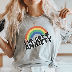 May include: A gray t-shirt with a rainbow and stars graphic and the text "I've got anxiety".