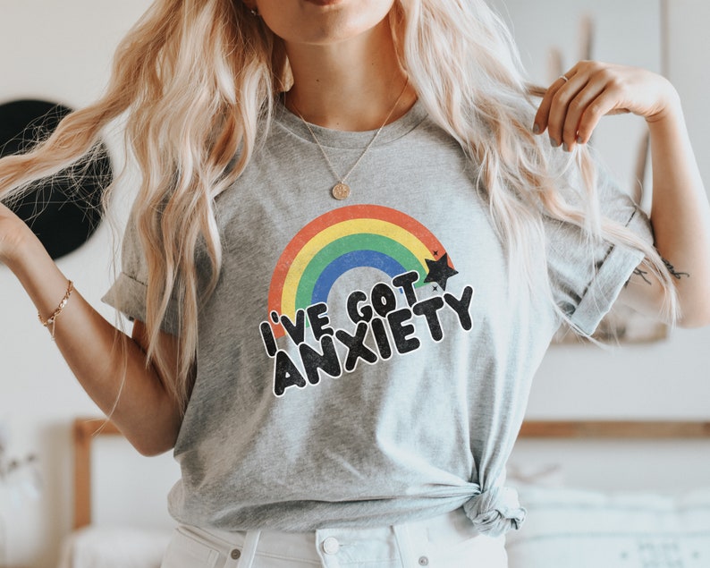 May include: A gray t-shirt with a rainbow and stars graphic and the text "I've got anxiety".