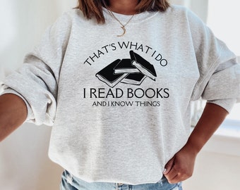 May include: Gray sweatshirt with the text "That's what I do I read books and I know things" and a graphic of stacked books.