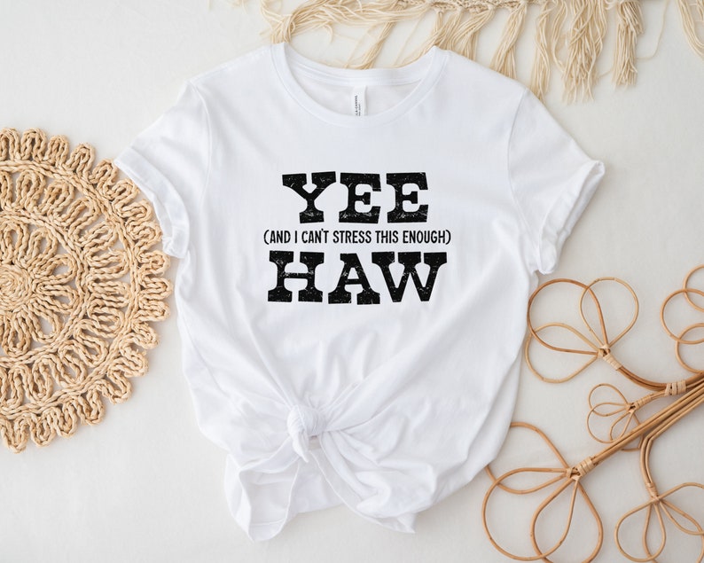 Op de afbeelding: Wit T-shirt met zwarte tekst die "Yee (and I can't stress this enough) Haw" luidt.