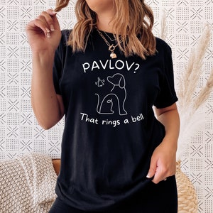 May include: Black t-shirt with a white graphic of a dog and the text "Pavlov? That rings a bell."