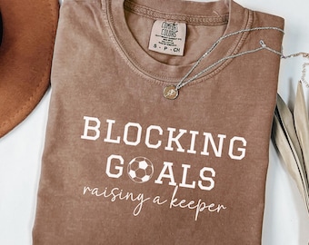 Maillot de gardien de but de football pour maman bloquant des buts élevant un gardien