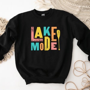 May include: Black sweatshirt with a colorful graphic that says "Lake Mode" with a paddle.