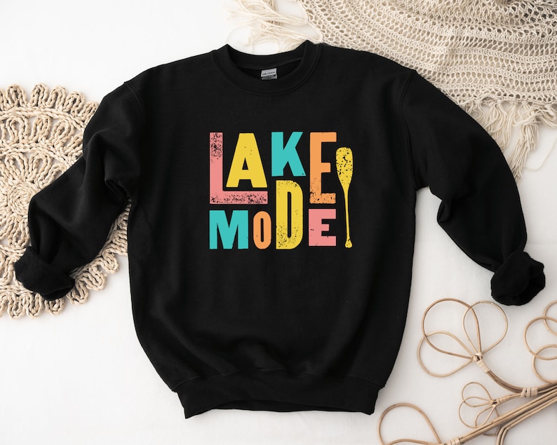 May include: Black sweatshirt with a colorful graphic that says "Lake Mode" with a paddle.