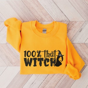 May include: A yellow sweatshirt with the text "100% that WITCH" in black with a witch graphic.