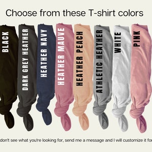 May include: A selection of t-shirt colors, including black, dark grey heather, heather navy, heather mauve, heather peach, athletic heather, white, and pink.