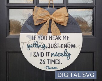 May include: A round wooden door hanger with a burlap bow. The door hanger is painted white and black with the text "IF YOU HEAR ME yelling, JUST KNOW I SAID IT nicely 26 TIMES. -The mom" in teal blue lettering.