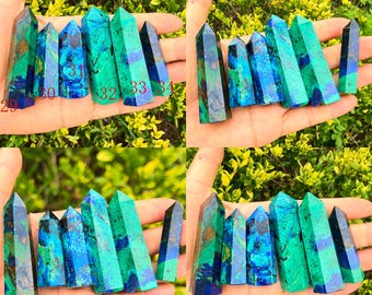 Könnte beinhalten: Eine Sammlung von sechs polierten Azurit-Malachit-Kristallspitzen mit lebhaften blau-grünen Marmormustern. Die Steine sind in roter Schrift von 29 bis 34 nummeriert und zeigen ausgeprägte mineralische Einschlüsse sowie spitze Enden.