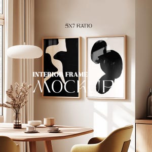 May include: Two black and white abstract art prints in wooden frames hanging on a beige wall above a wooden table with two chairs. The text "5x7 Ratio" and "Interior Frame Mockup" is visible in the image.