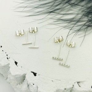 Two pairs of silver bar studs