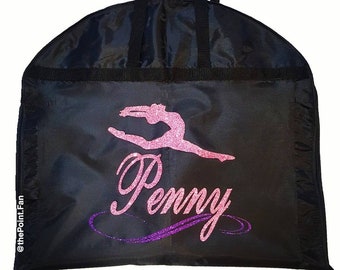 May include: Black garment bag with a pink and purple glitter design of a gymnast and the name "Penny".