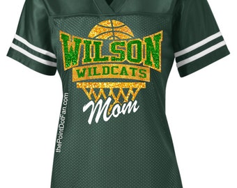 May include: Green and gold basketball jersey with the text "Wilson Wildcats Mom" on the front.
