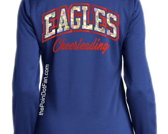 May include: A royal blue long-sleeve zip-up jacket featuring the word EAGLES in iridescent block letters with a red outline, the word Cheerleading in red script, and the text thePoinDotFan.com printed vertically on the back.