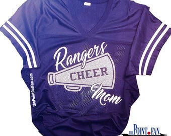 May include: Purple and white jersey with the words "Rangers Cheer Mom" and a megaphone graphic. The text is in silver glitter.
