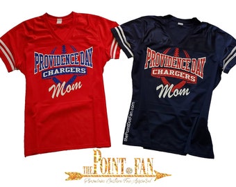 May include: Two red and navy blue jersey shirts with white trim. The shirts have the text "Providence Day Chargers Mom" in white, red, and blue glitter.