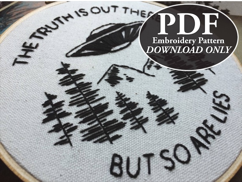 May include: Embroidered hoop art featuring a black UFO, trees, and mountains. The text reads "THE TRUTH IS OUT THERE BUT SO ARE LIES." A PDF embroidery pattern download is available.